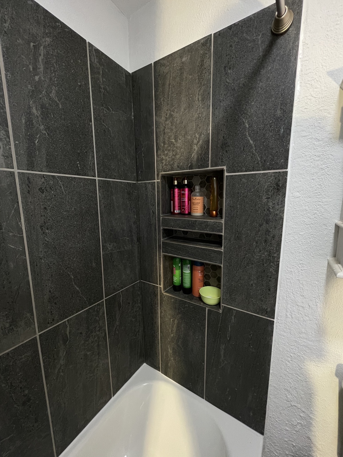 Tiled shower niche detail.